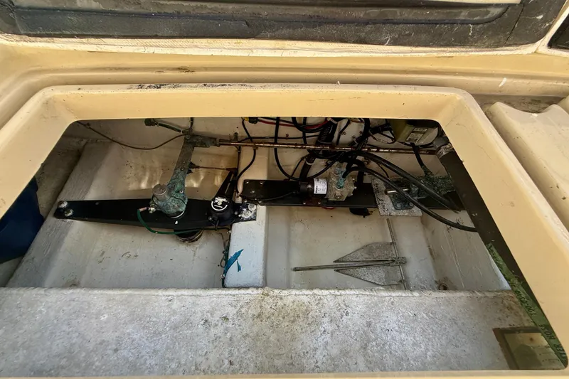 Slide: The Image of Engine compartment of a 1999 Legacy 40 boat, showing mechanical components and wiring. - 65