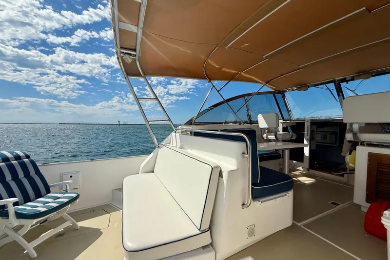 Slide: The Image of Spacious deck of 1999 Legacy 40 yacht with seating, under a sunny sky. - 68