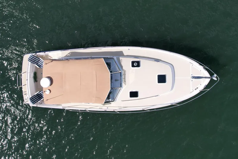 Slide: The Image of Aerial view of 1999 Legacy 40 boat on water, showcasing deck and canopy. - 7