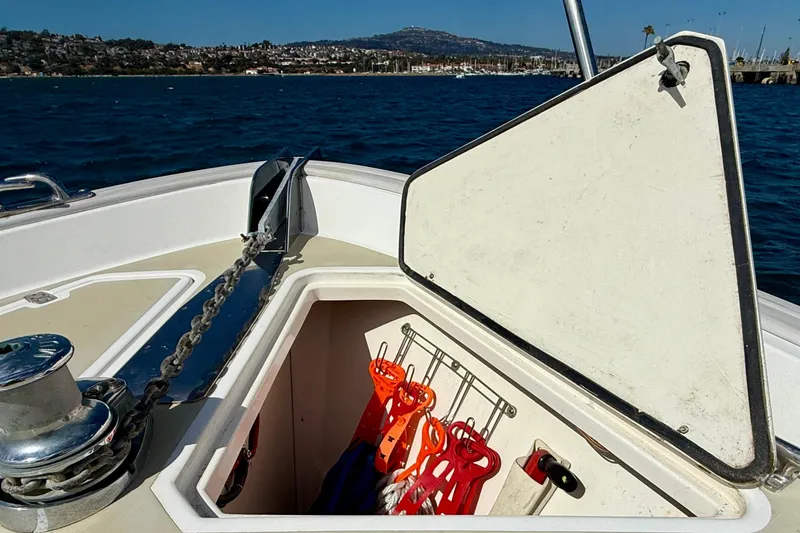 Slide: The Image of Open storage compartment on 1999 Legacy 40 boat with life jackets, ocean view. - 72