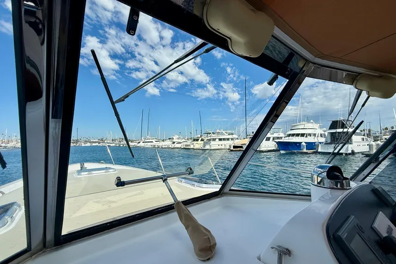 Slide: The Image of View from Legacy 40 boat cockpit, overlooking marina with yachts under blue sky. - 75