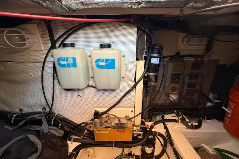 Slide: The Image of Engine room of 1999 Legacy 40 boat with dual fluid tanks and wiring. - 79