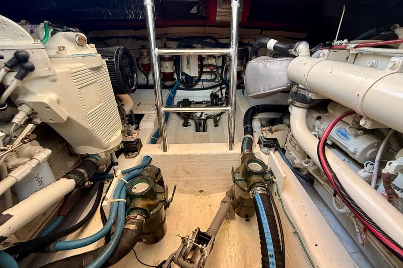 Slide: The Image of Engine room of a 1999 Legacy 40 boat with visible machinery and pipes. - 80