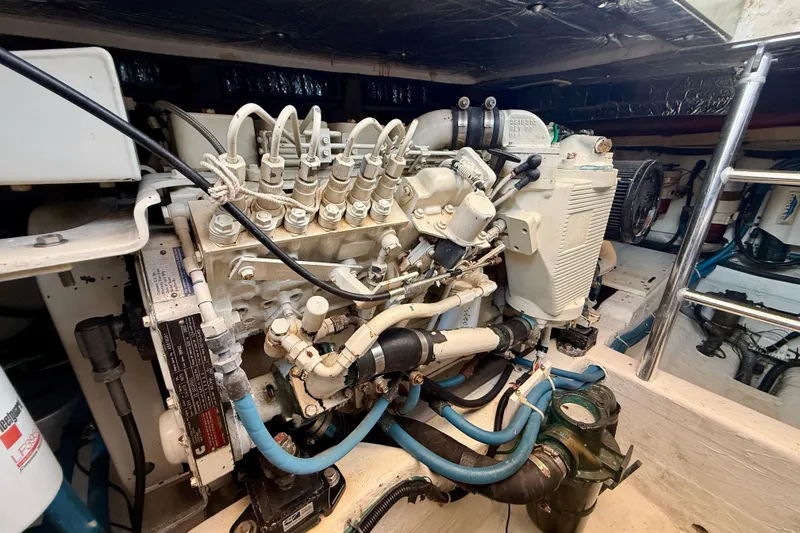 Slide: The Image of Engine room of a 1999 Legacy 40 boat, showcasing detailed mechanical components. - 82