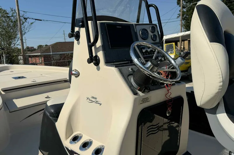 Slide: The Image of 2014 Blue Wave 2000 PureBay boat console with steering wheel and controls. - 11