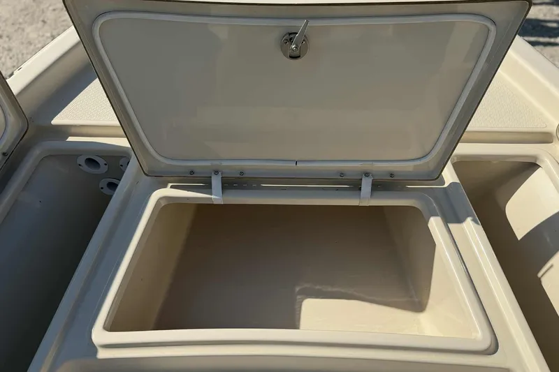 Slide: The Image of Open storage compartment on 2014 Blue Wave 2000 PureBay boat, beige interior. - 14