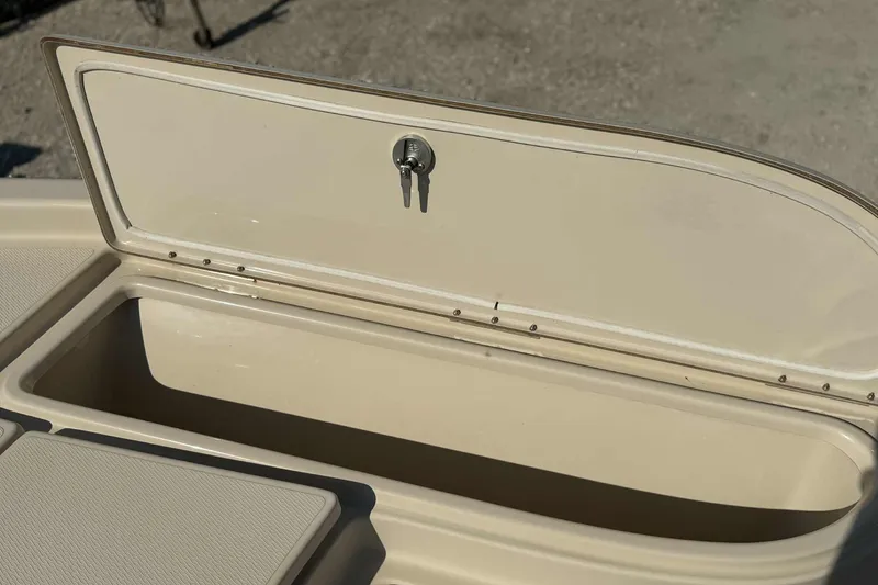 Slide: The Image of Open storage compartment on 2014 Blue Wave 2000 PureBay boat, beige interior. - 15