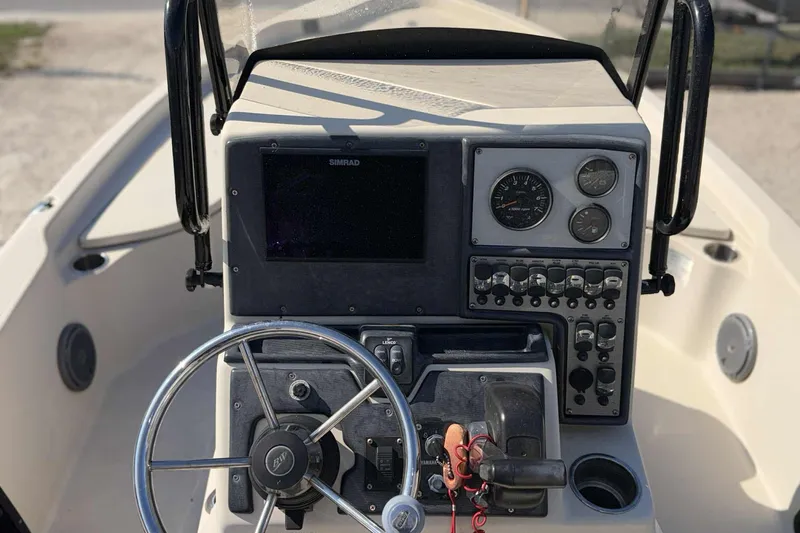 Slide: The Image of Control panel of a 2014 Blue Wave 2000 PureBay boat with steering wheel and gauges. - 8