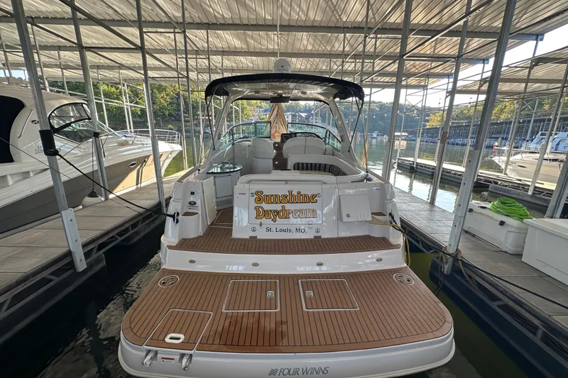 Slide: The Image of 2006 Four Winns 378 Vista boat cruising on a scenic lake with autumn foliage. - 2