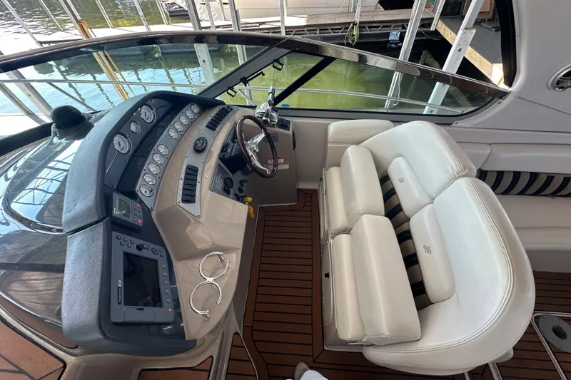 Slide: The Image of 2006 Four Winns 378 Vista yacht docked in a marina, featuring a spacious deck. - 22
