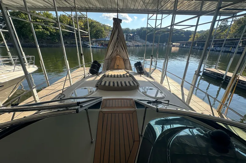 Slide: The Image of 2006 Four Winns 378 Vista yacht docked in a marina, showcasing sleek design and spacious deck. - 23