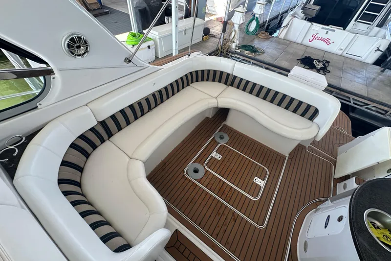 Slide: The Image of 2006 Four Winns 378 Vista boat dashboard with gauges and controls, docked by a scenic lake. - 26