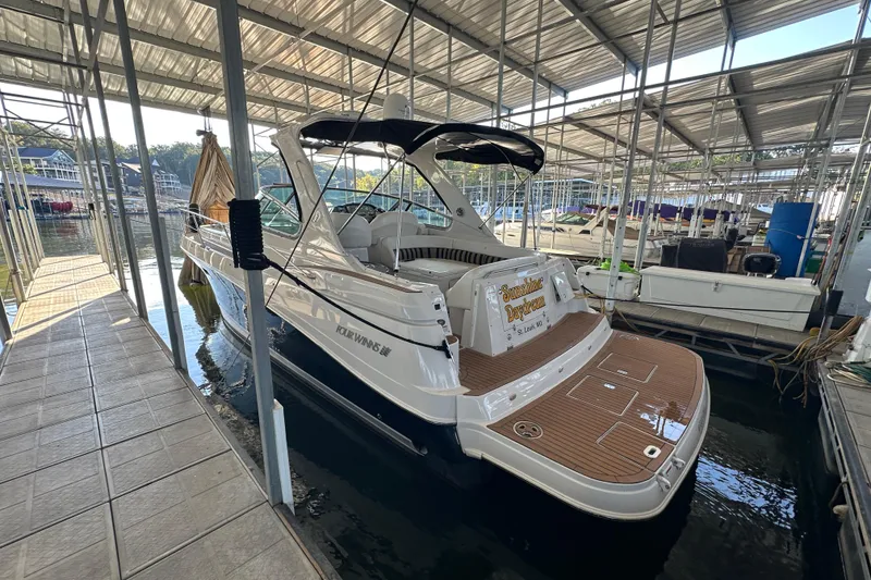 Slide: The Image of 2006 Four Winns 378 Vista boat cruising on a scenic lake with autumn foliage. - 3