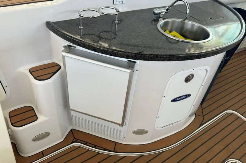 Slide: The Image of Steering wheel and dashboard of 2006 Four Winns 378 Vista boat, featuring gauges and controls. - 30