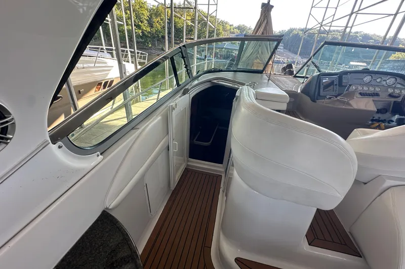 Slide: The Image of 2006 Four Winns 378 Vista boat helm with white seating and control panel. - 32
