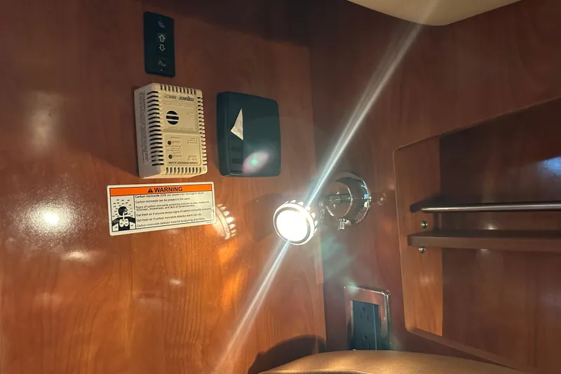 Slide: The Image of 2006 Four Winns 378 Vista boat interior with white seating and wooden deck. - 37