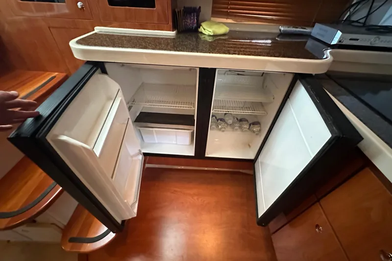 Slide: The Image of Luxurious 2006 Four Winns 378 Vista yacht interior with wood finish and cozy seating. - 49