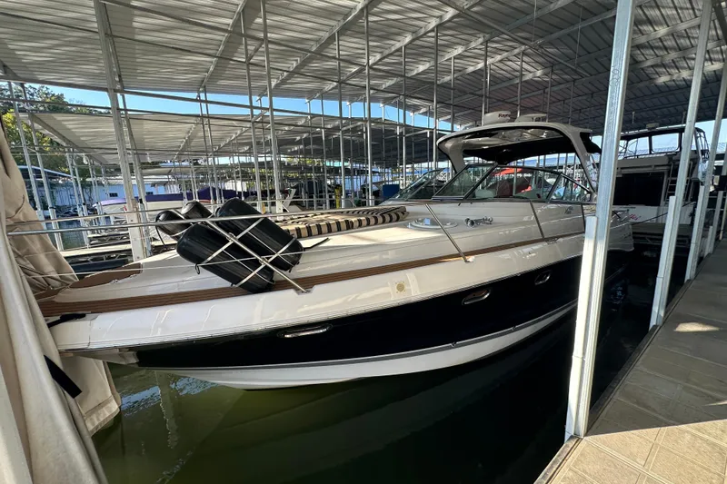 Slide: The Image of 2006 Four Winns 378 Vista boat cruising on a scenic lake with wooded shoreline. - 5