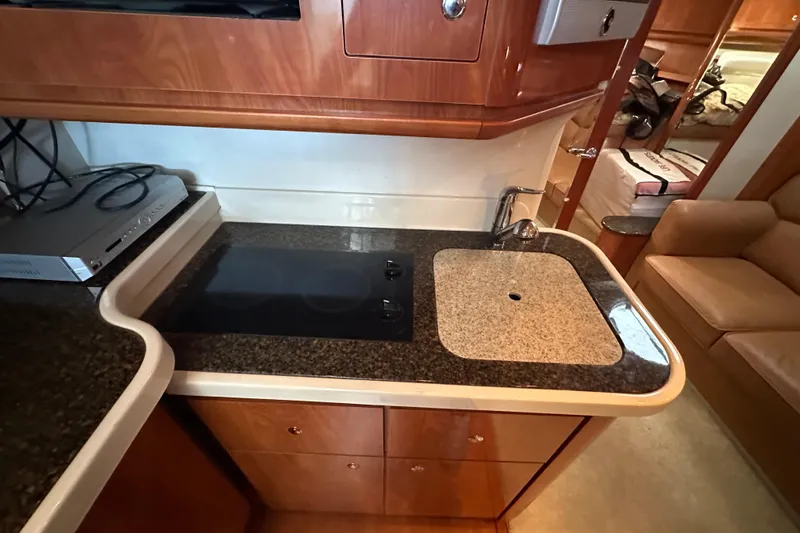 Slide: The Image of Luxurious interior of 2006 Four Winns 378 Vista yacht with leather seating and wood finishes. - 51