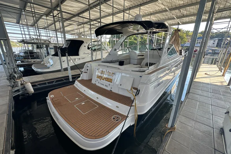 Slide: The Image of 2006 Four Winns 378 Vista boat on a serene lake with wooded shoreline. - 6