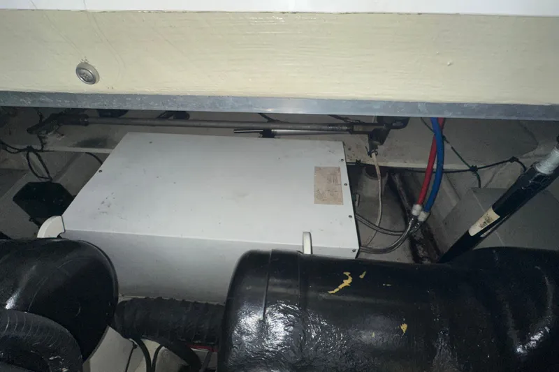 Slide: The Image of Engine compartment of a 2006 Four Winns 378 Vista boat, showing mechanical components. - 74