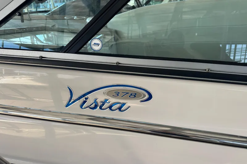 Slide: The Image of 2006 Four Winns 378 Vista boat on a lake with autumn trees in the background. - 9