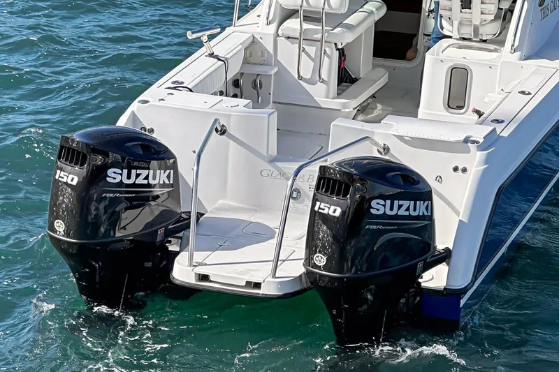 Slide: The Image of 2007 Glacier Bay 2680 Coastal Runner with twin Suzuki 150 outboard motors on water. - 13