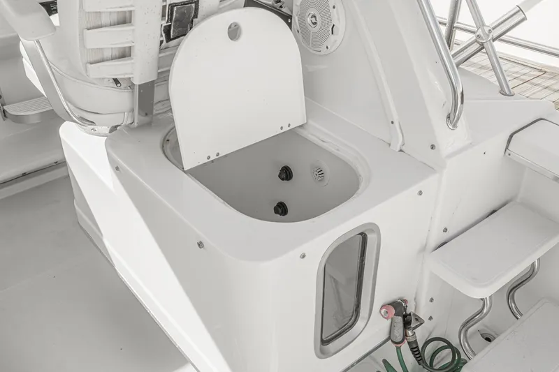 Slide: The Image of 2007 Glacier Bay 2680 Coastal Runner boat interior with open storage compartment. - 22