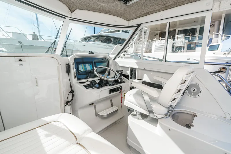 Slide: The Image of 2007 Glacier Bay 2680 Coastal Runner interior with helm, seating, and navigation equipment. - 25