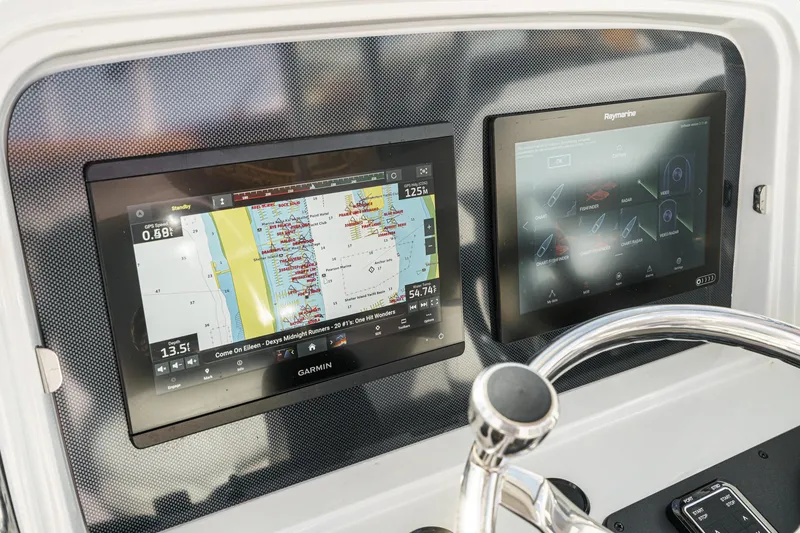 Slide: The Image of Dashboard of 2007 Glacier Bay 2680 Coastal Runner with dual navigation screens. - 29