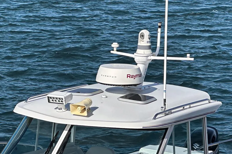 Slide: The Image of 2007 Glacier Bay 2680 Coastal Runner boat with radar and camera equipment on the roof. - 31