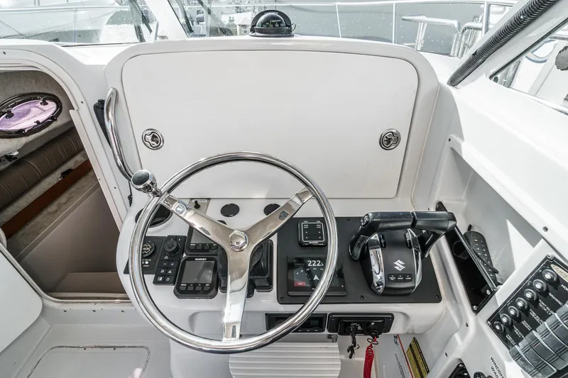 Slide: The Image of Helm of 2007 Glacier Bay 2680 Coastal Runner with steering wheel and controls. - 35