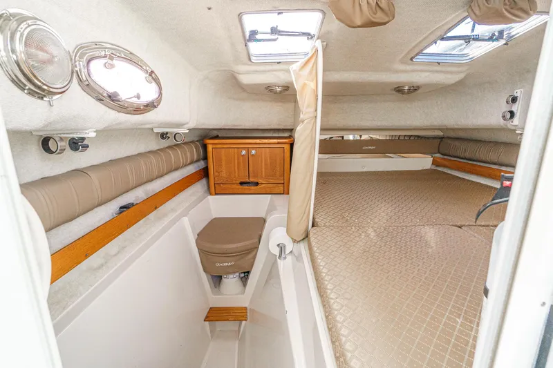 Slide: The Image of Interior of 2007 Glacier Bay 2680 Coastal Runner boat, featuring cozy cabin and seating. - 36