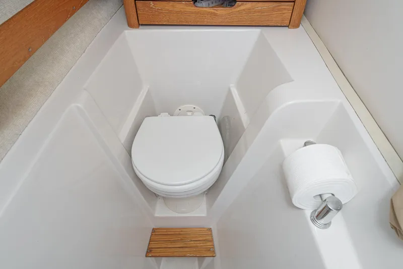 Slide: The Image of 2007 Glacier Bay 2680 Coastal Runner boat bathroom with toilet and toilet paper holder. - 37