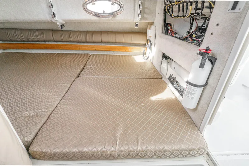 Slide: The Image of 2007 Glacier Bay 2680 Coastal Runner cabin interior with beige cushions and safety equipment. - 39