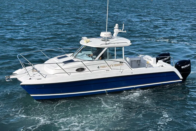 Slide: The Image of 2007 Glacier Bay 2680 Coastal Runner boat on open water, featuring dual Suzuki engines. - 7