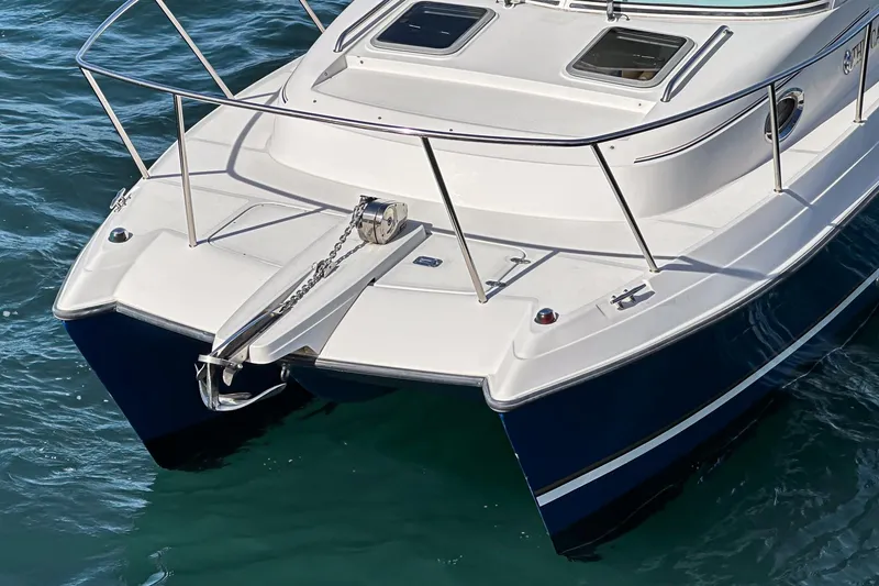 Slide: The Image of 2007 Glacier Bay 2680 Coastal Runner catamaran on water, featuring sleek design and anchor. - 8