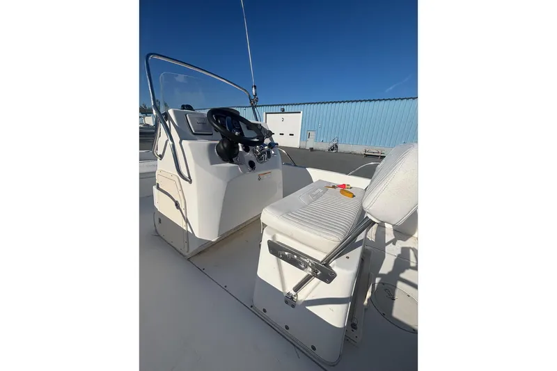 Slide: The Image of 2008 Boston Whaler 180 Dauntless boat interior with steering console and seating. - 12