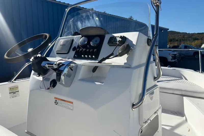 Slide: The Image of 2008 Boston Whaler 180 Dauntless boat console with steering wheel and controls. - 9