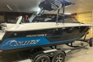 The Image of 2016 Monterey 238 Surf boat on trailer in garage setting. - 0