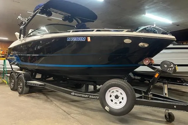 Slide: The Image of 2016 Monterey 238 Surf boat on trailer in indoor storage. - 14