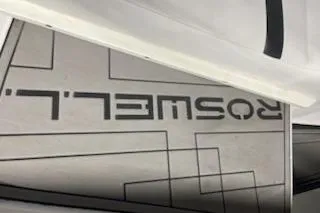 Slide: The Image of Close-up of a 2016 Monterey 238 Surf boat with Roswell branding. - 18