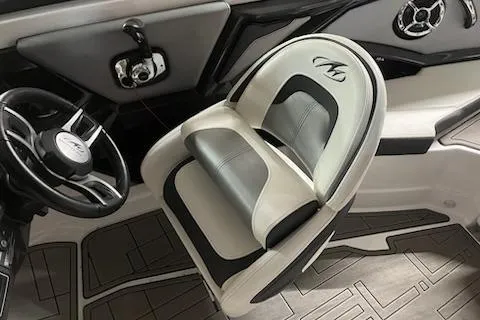 Slide: The Image of 2016 Monterey 238 Surf boat interior with steering wheel and cushioned seat. - 22