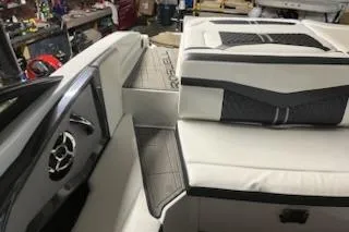 Slide: The Image of 2016 Monterey 238 Surf boat interior with cushioned seating and sleek design. - 23