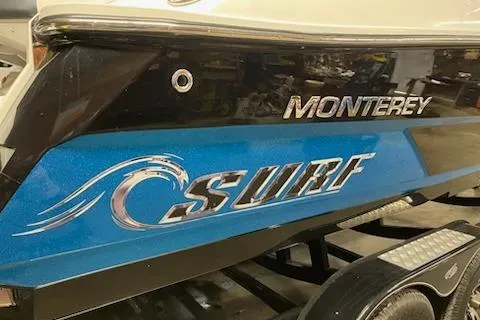 Slide: The Image of 2016 Monterey 238 Surf boat with blue wave design on the side. - 5