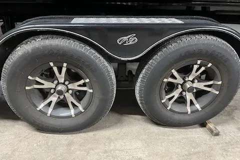 Slide: The Image of Trailer wheels of a 2016 Monterey 238 Surf boat on a concrete floor. - 6