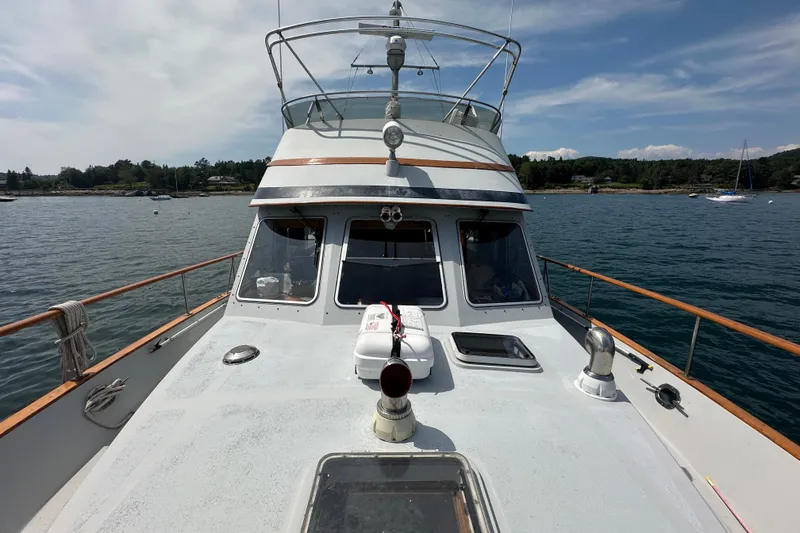 Slide: The Image of 1987 Albin North Sea Trawler on calm waters, showcasing deck and cabin under clear skies. - 30