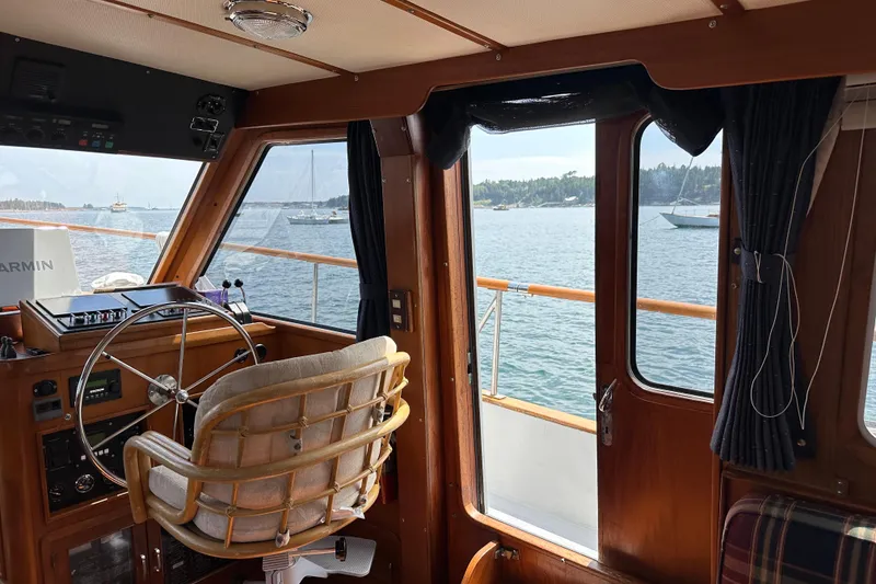 Slide: The Image of Interior view of 1987 Albin North Sea Trawler with steering wheel and scenic ocean backdrop. - 45