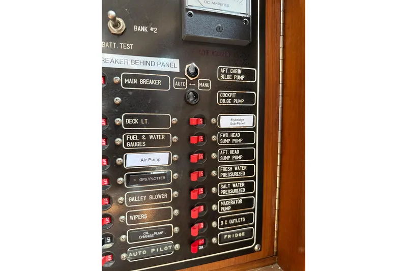 Slide: The Image of Control panel of a 1987 Albin North Sea Trawler with labeled switches and gauges. - 47