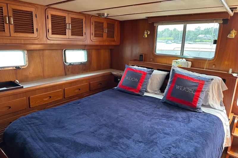 Slide: The Image of Cozy cabin interior of 1987 Albin North Sea Trawler with wooden furnishings and comfortable bedding. - 11